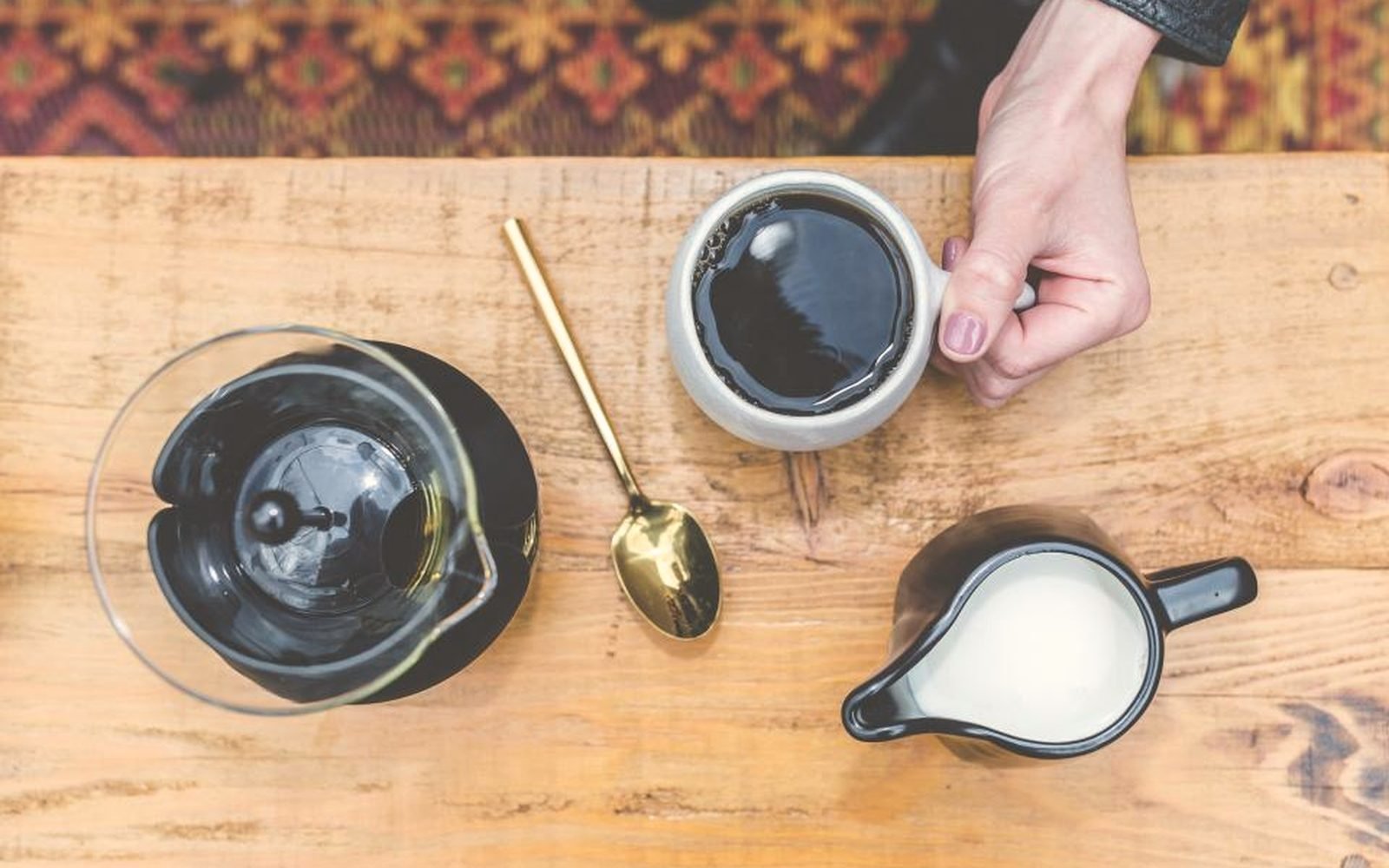 Coffee being poured on a wooden table